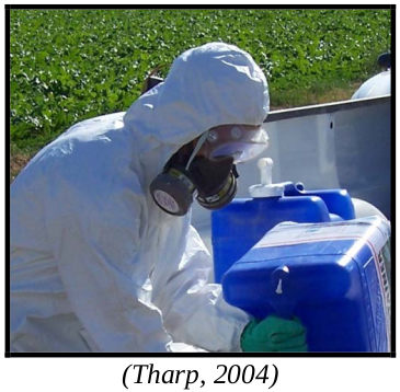 Person in full PPE suit with respirator. Caption: Tharp, 2004