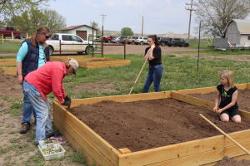 Volunteers filling plots with dirt