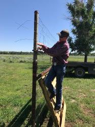 Teenager building fence