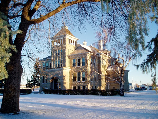 Teton County Courthouse, a three story sandstone building, in Choteau, Montana in winter.