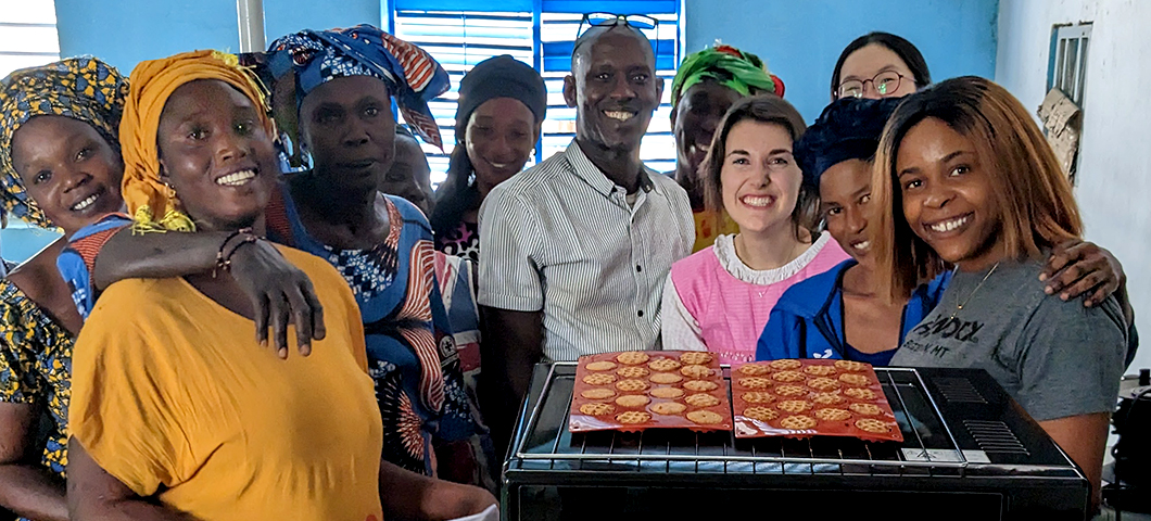 Lab students and faculty in Senegal conducting baking trials with a group of women entrepreneurs.