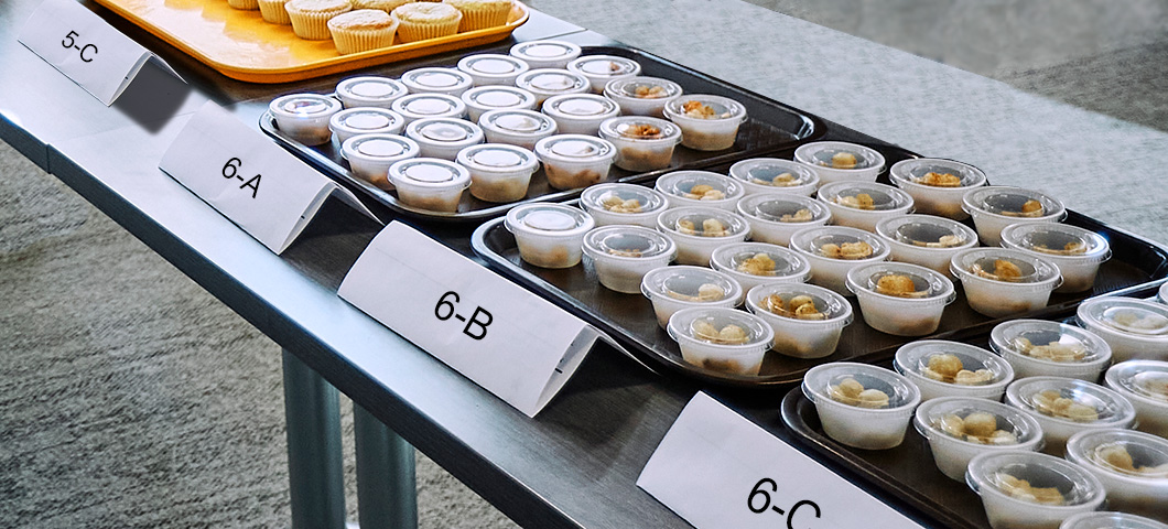 containers of food products organized on a table for sensory testing