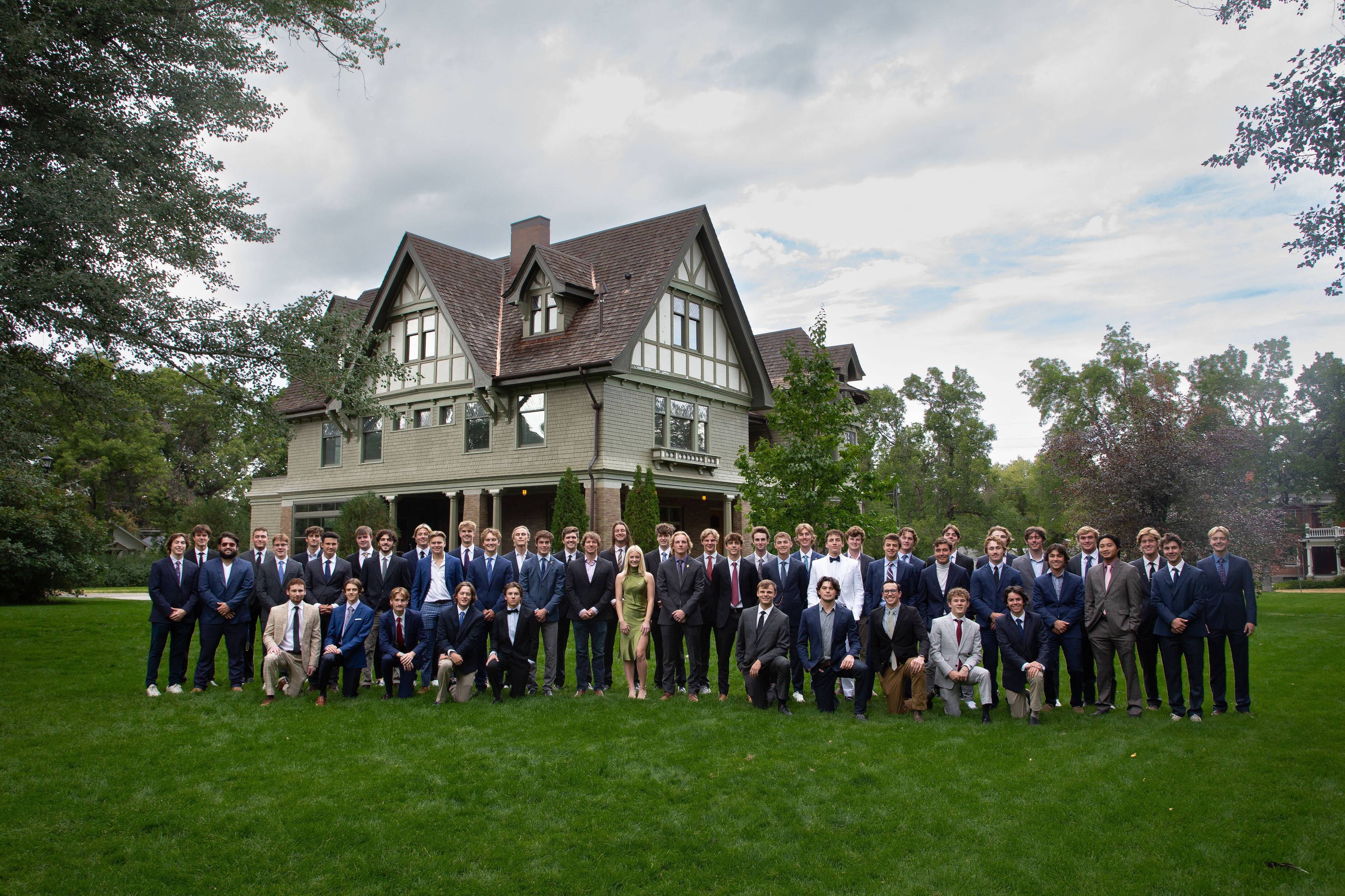 SAE members are standing in front of the Story Mansion