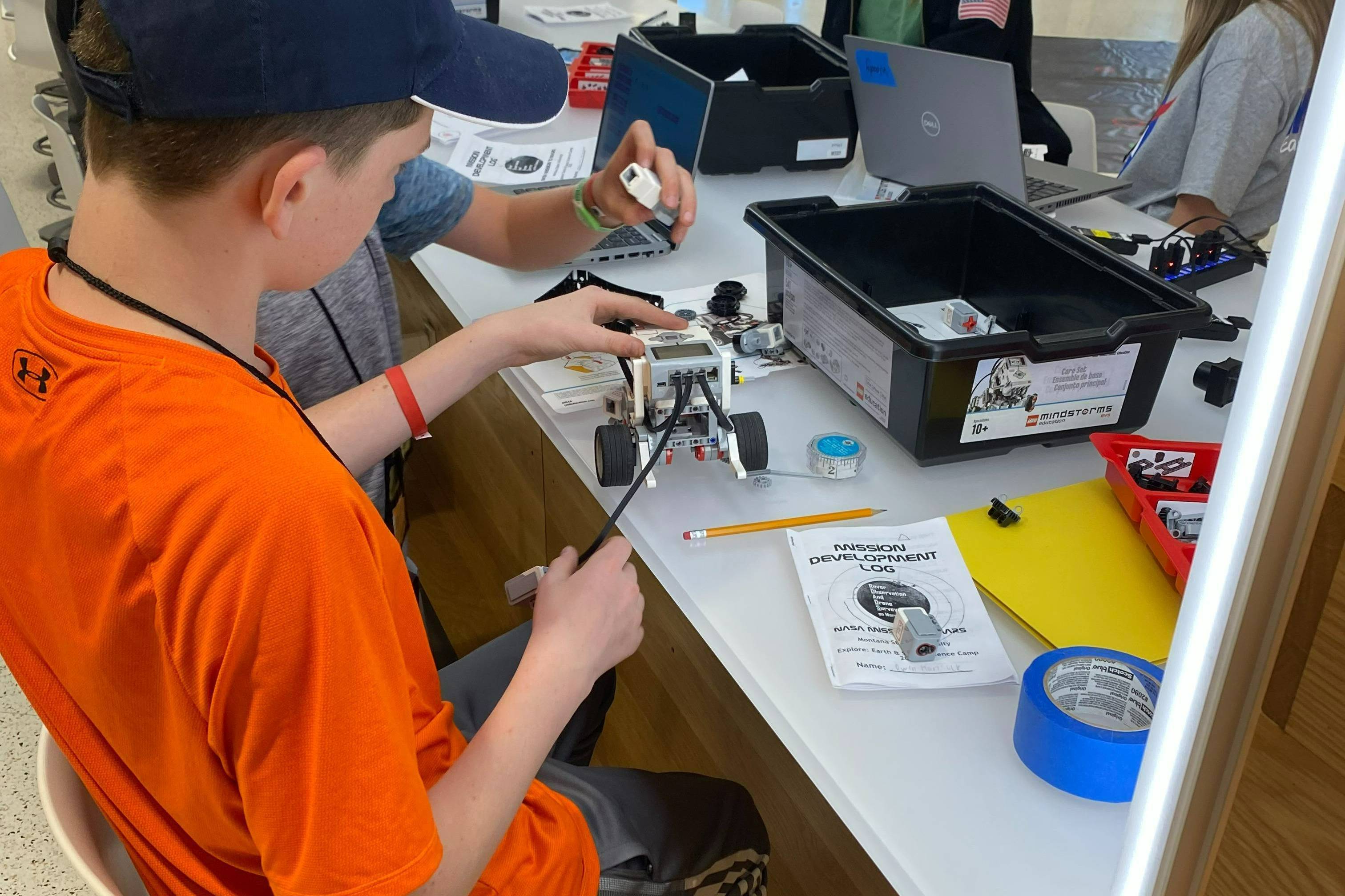 Student assembling a robot at Earth and Space Science Camp