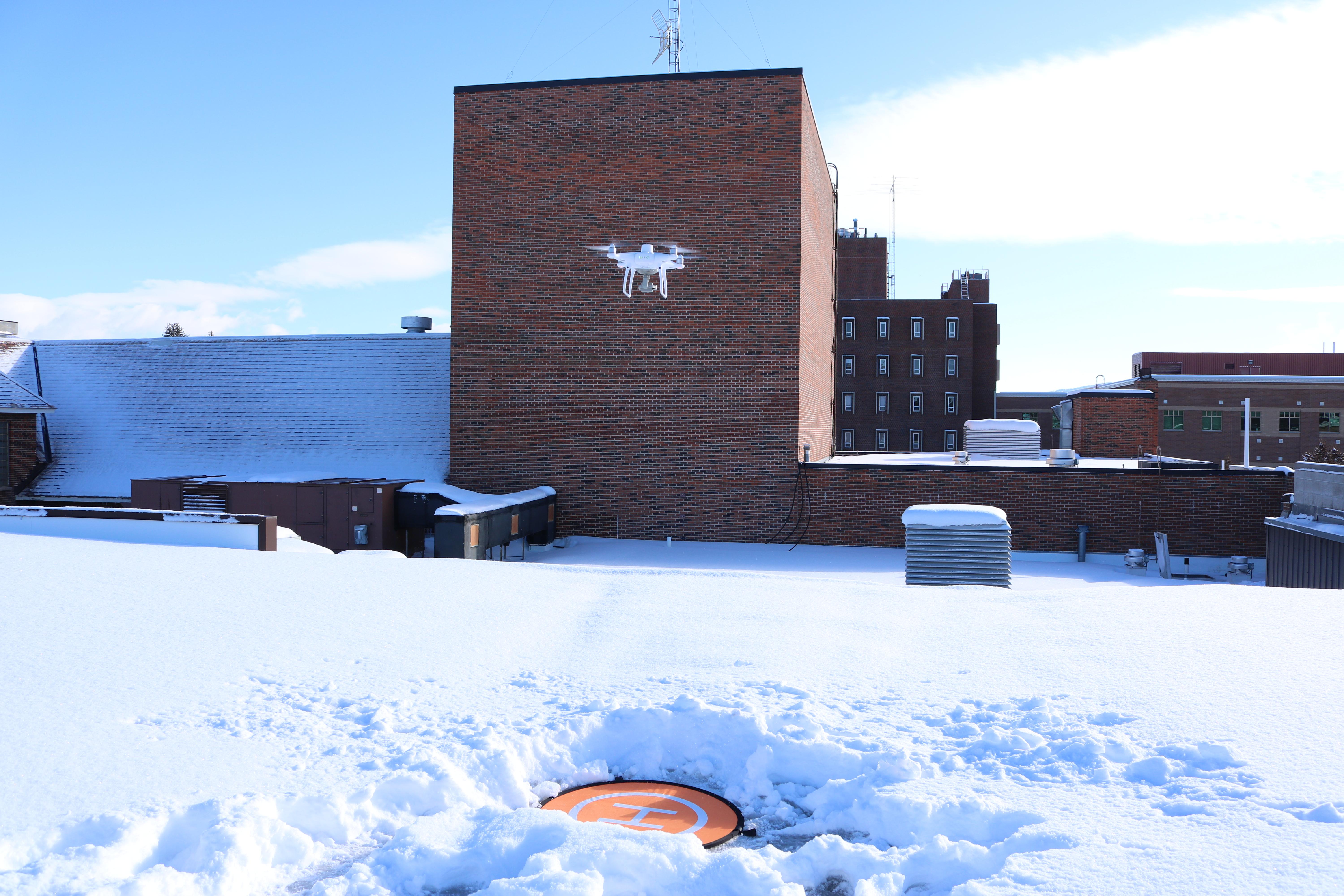 Drone flying over the roof of the SUB to map snow levels
