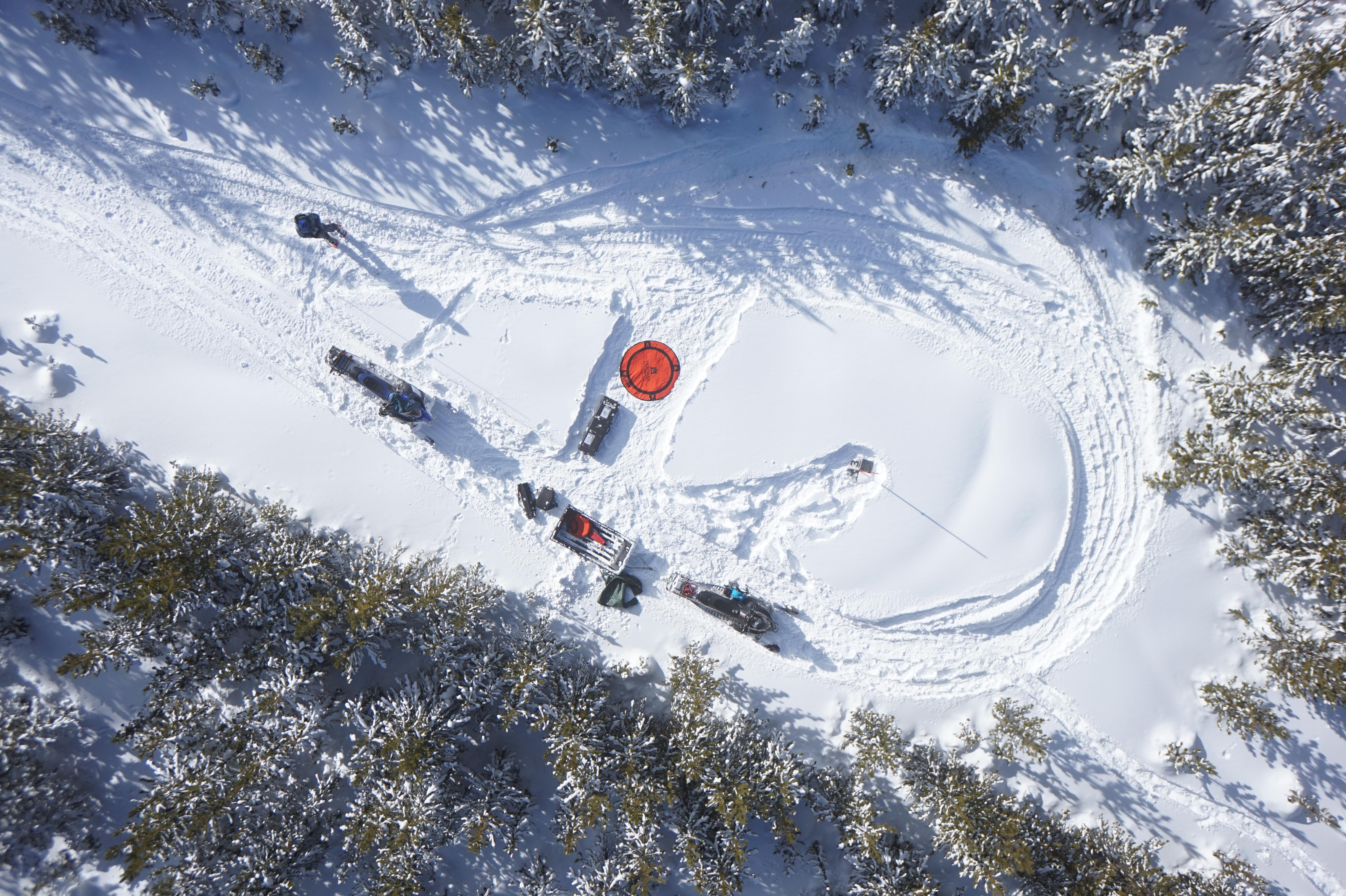Drone flies over mapping site of the GCF in a snowy valley