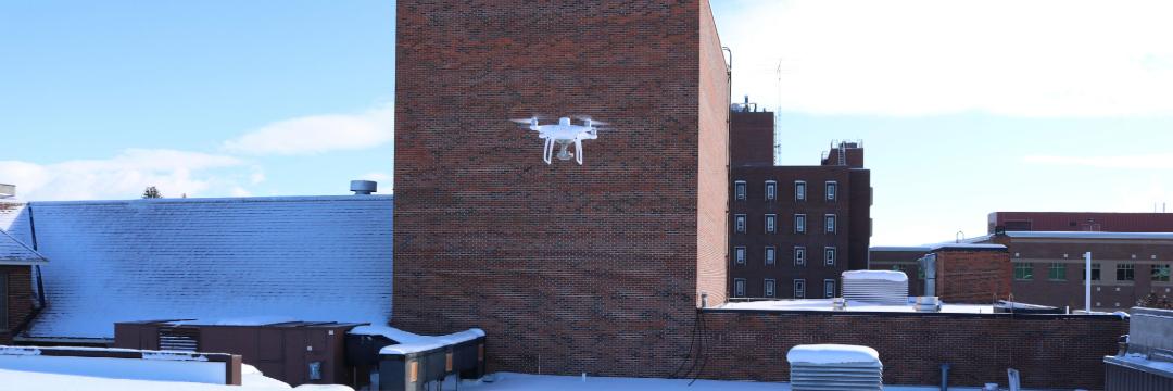 Drone flying over the roof of the SUB to map snow levels