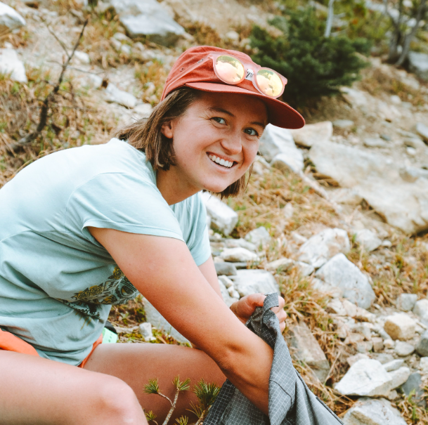 Maddy Grubb, grabbing some sort of thing from a backpack