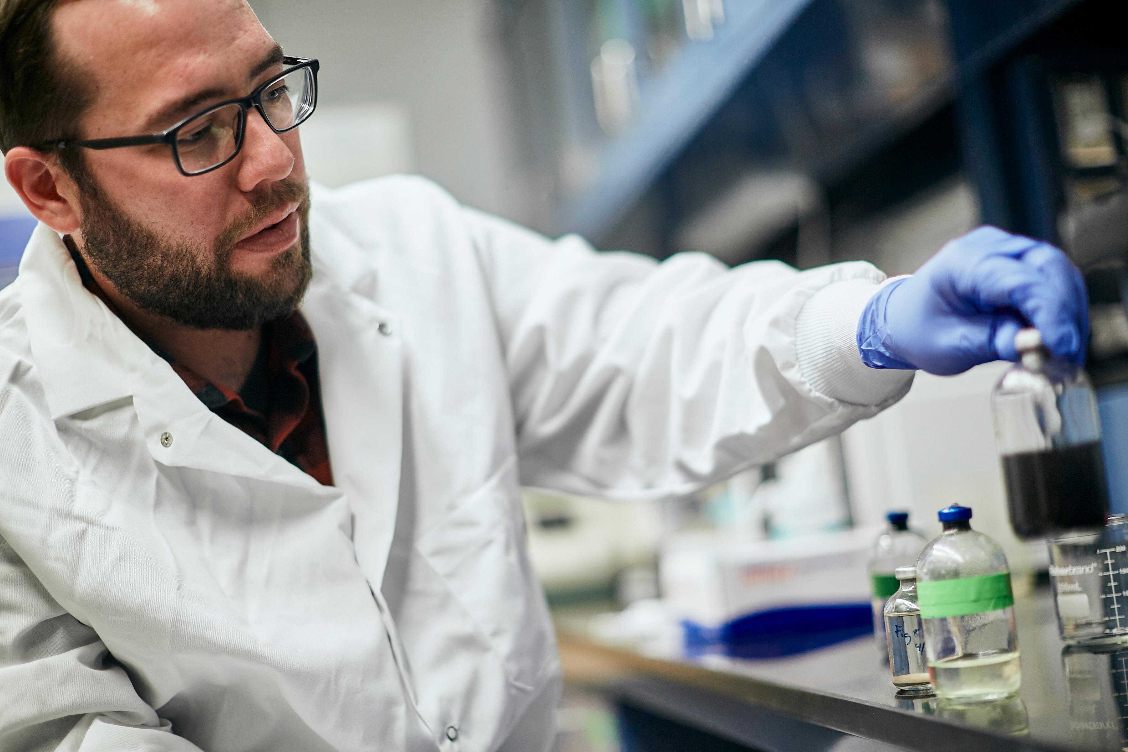 Male researcher working with chemicals in a lab