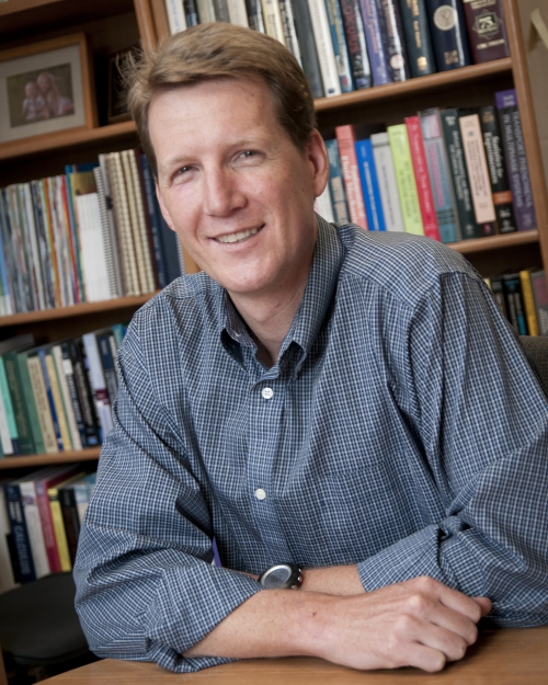 Jeffrey Heys a man in front of a bookshelf