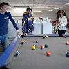 Three students playing pool in the basement of North Hedges  