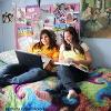 Two students on their laptop and notebook