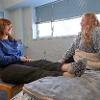 Two students sit in a Johnstone single room socializing 
