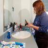 Student prepared to brush their teeth at the sink in a Johnstone single room 
