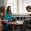 three quad residents playing board game