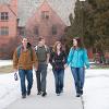 four residents leaving the quads and going to class
