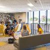 Students studying and hanging out in a common lounge area.