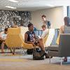 Students studying and hanging out in a common lounge area.