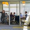 Students studying and hanging out in a common lounge area.