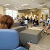 Students studying and hanging out in a common lounge area.