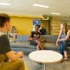 Students studying and hanging out in a common lounge area.