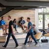 Students studying and hanging out in a common lounge area.