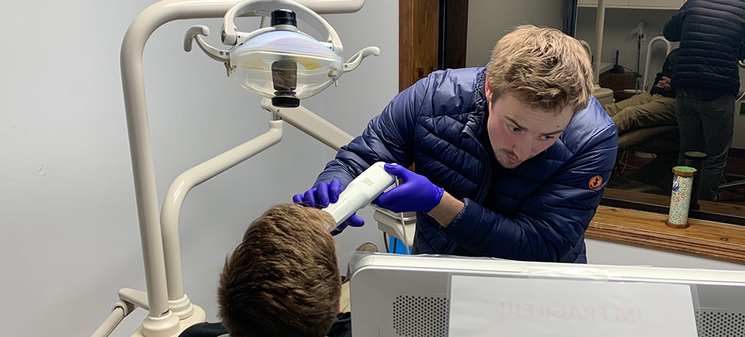 An HPA student performing orthodontic work on a patient