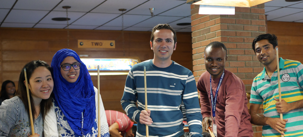 Orientation students play billiards during orientation.