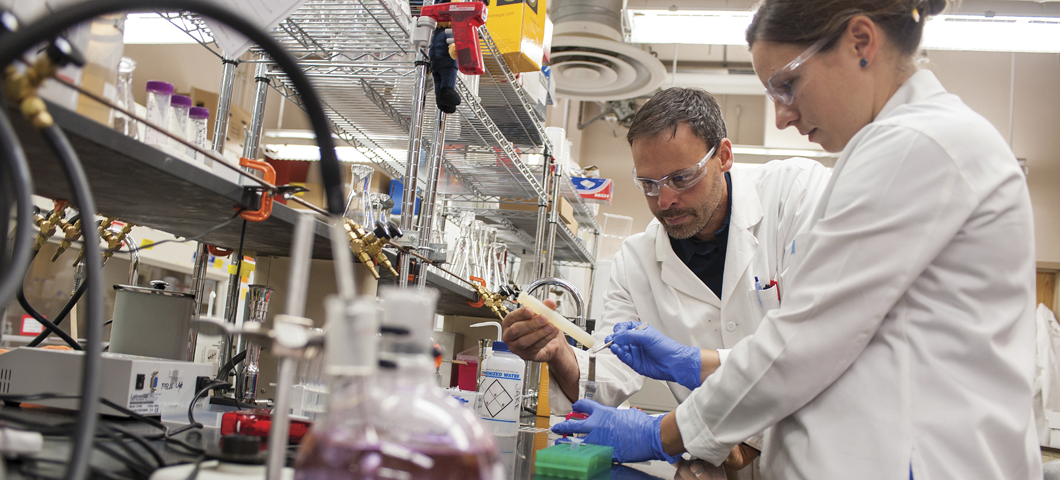 Two researchers performing tests at a lab at MSU.