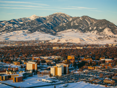 An arial view of campus and the Bridger Range during winter.