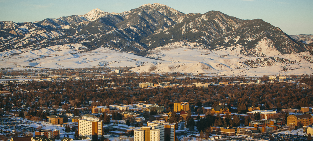 An arial view of campus and the Bridger Range during winter.