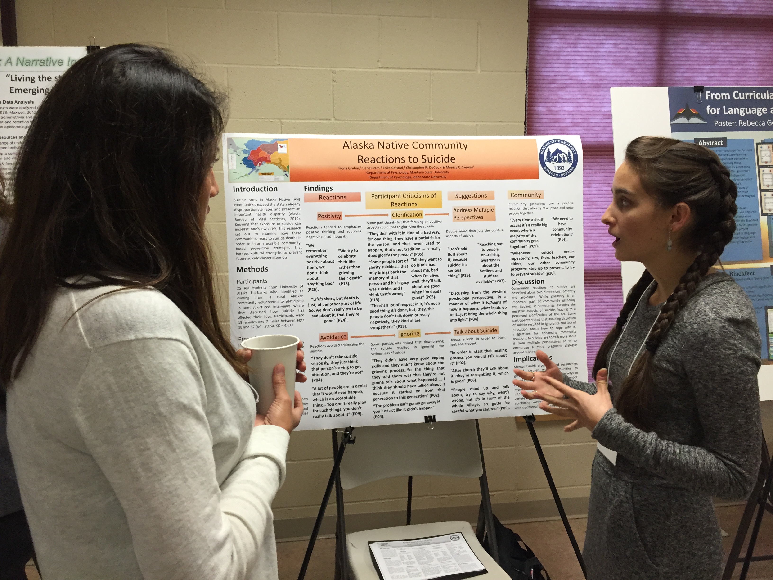 a Psychology student explains a poster on native American Suicide Rates