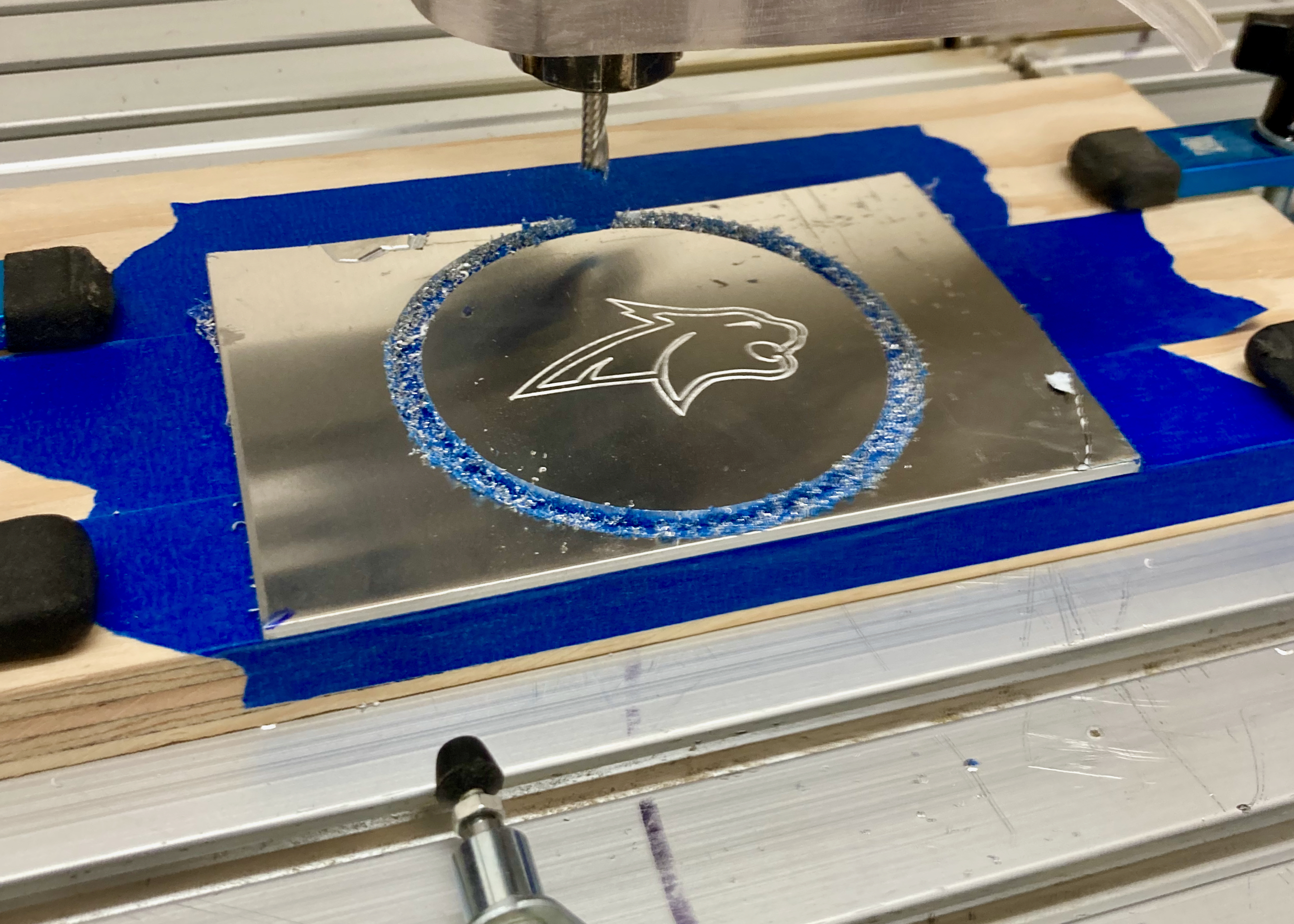 The Bobcat logo milled out of aluminum on the router table