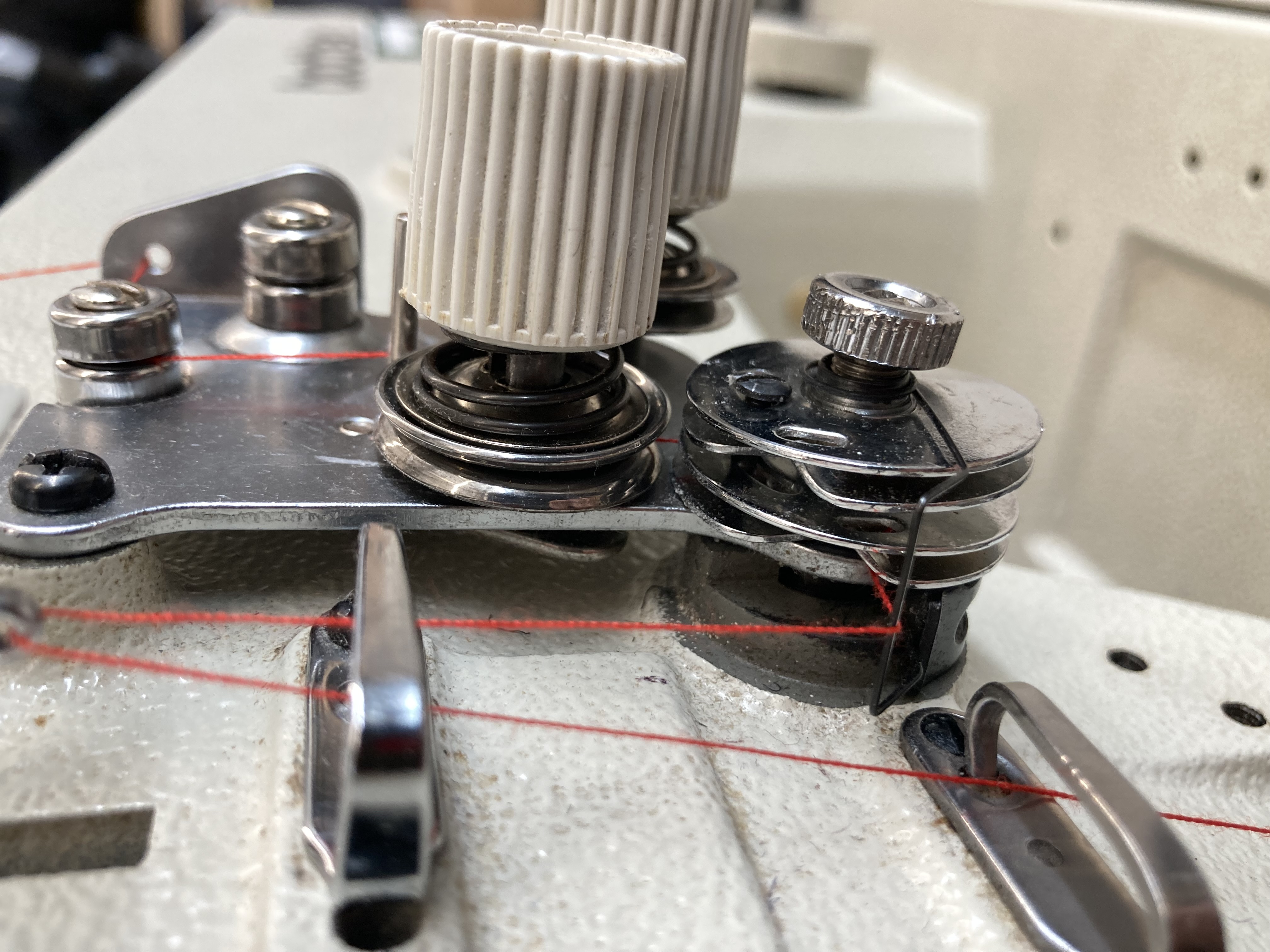 Thread path detail on an industrial sewing machine