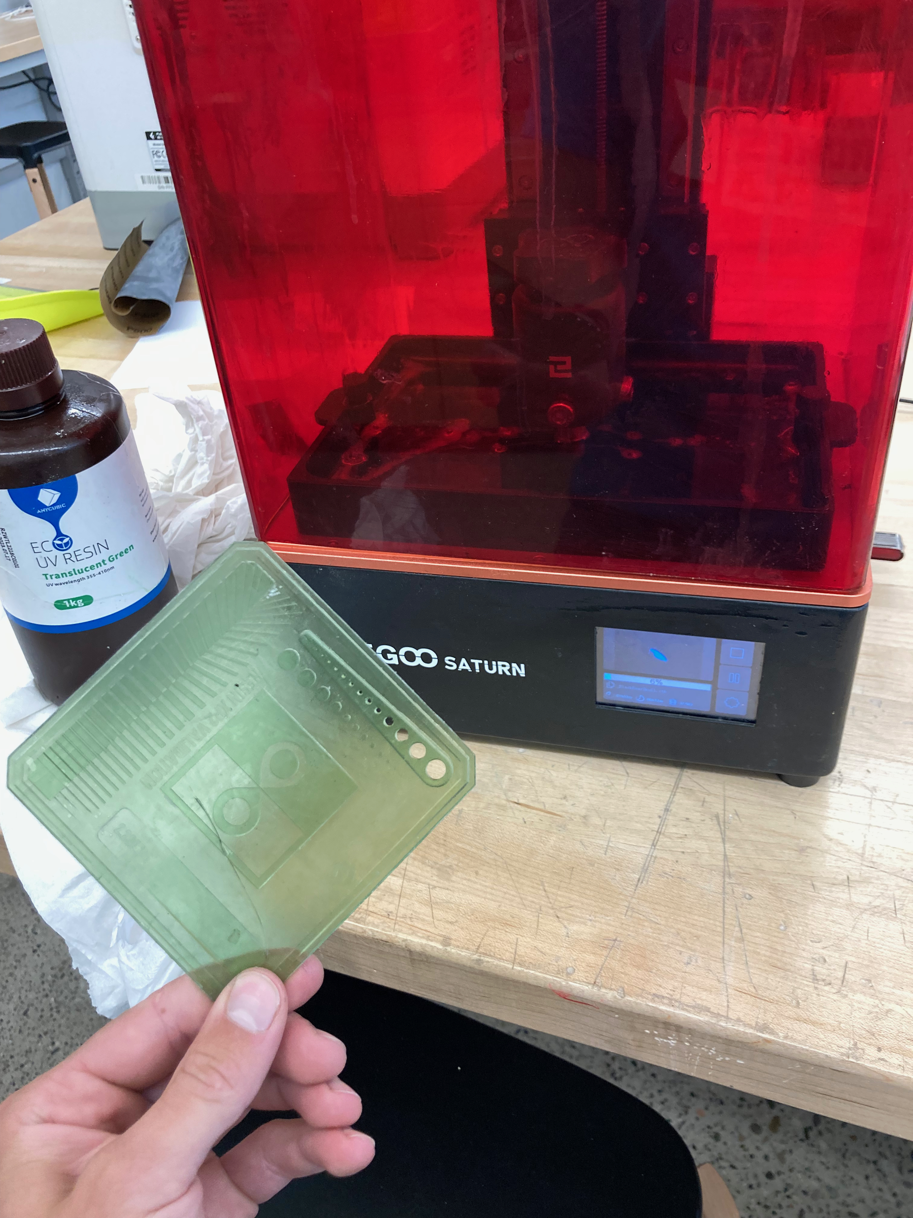 Tabletop resin printer with a test print held in front