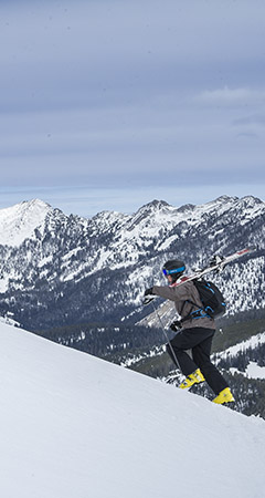 Skier walking up a hill