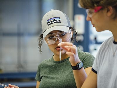 Chemistry student examines a pipette