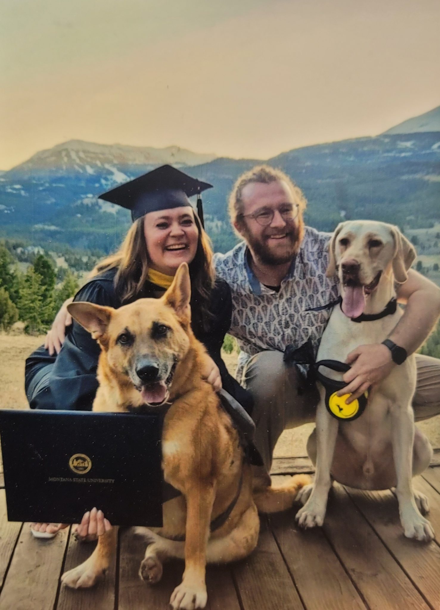 a photo of Corbin Arbizzani with someone else and dogs