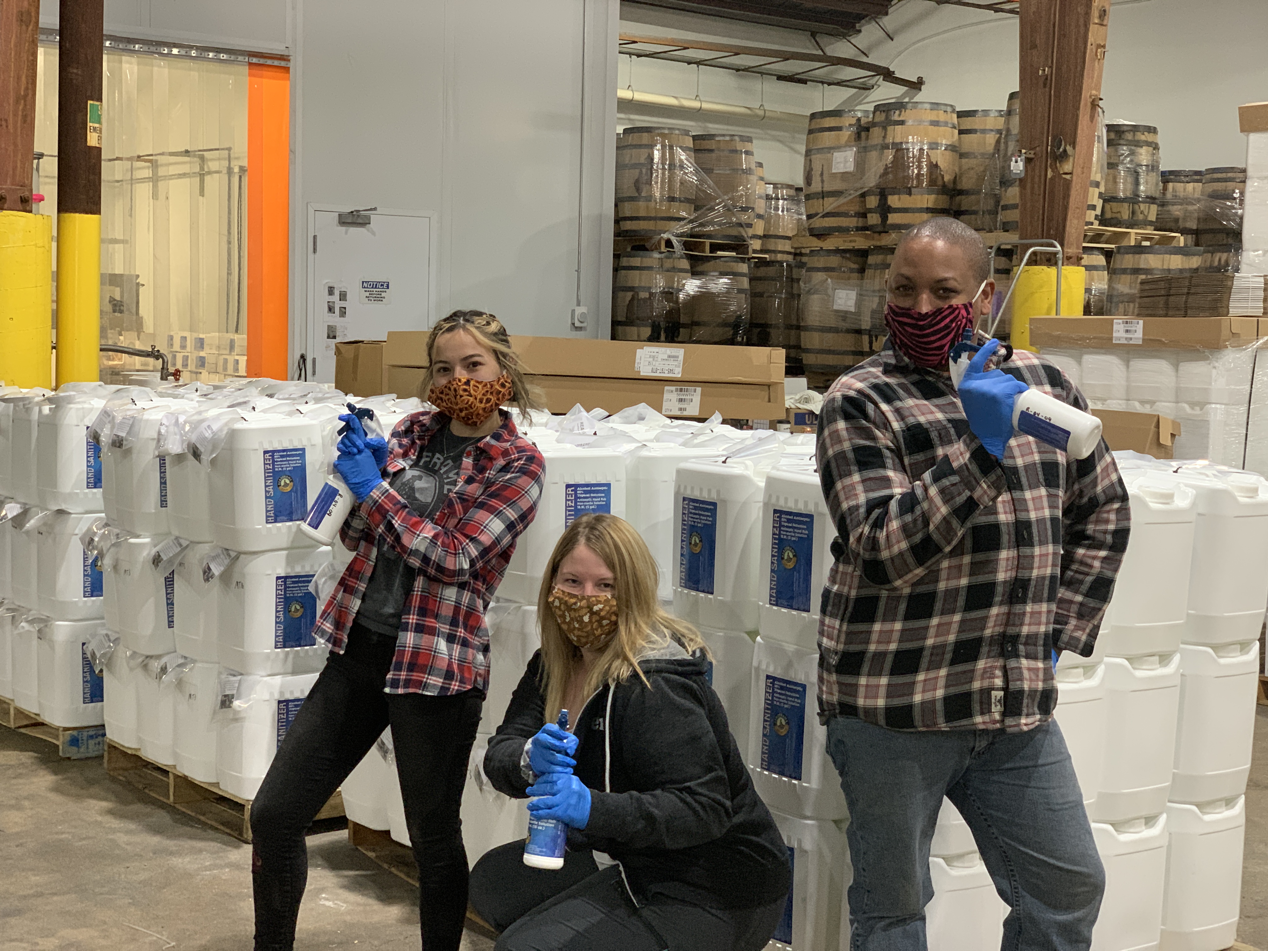 Headframe employees posing with hand sanitizer