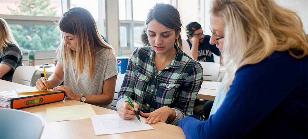 Professor helps student with a paper