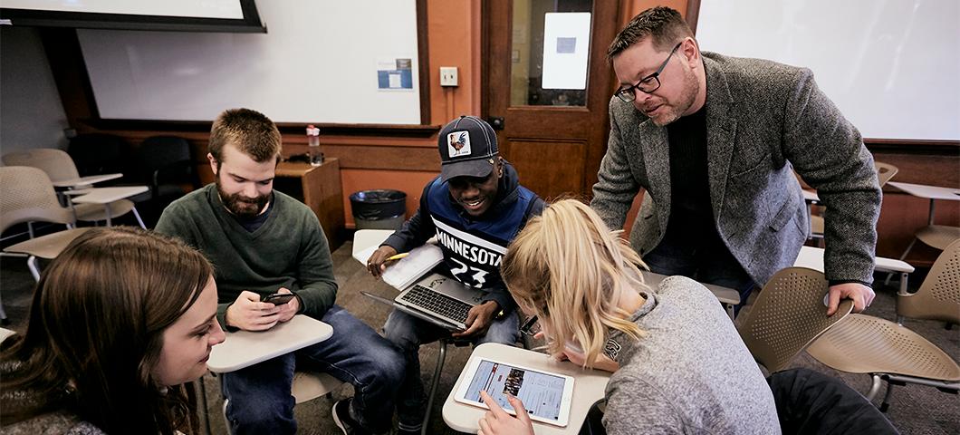 Professor David Parker works with small group of students