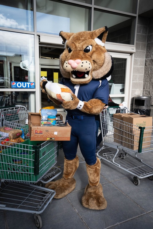 Champ Fills a Thanksgiving Box at the Food Bank