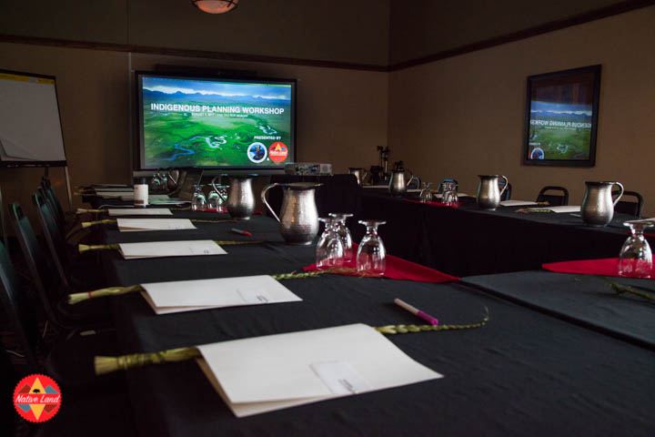 Empty meeting tables with sweetgrass braids