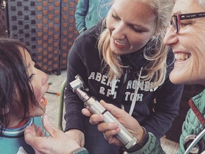 Checking child's throat in Ecuador