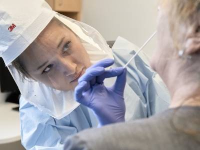 Nursing student swabbing patient