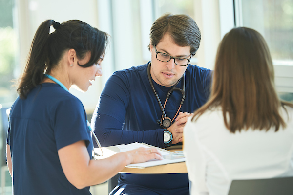 nursing students looking at a book