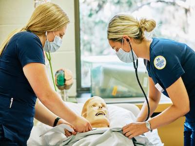 Two nurses checking vitals