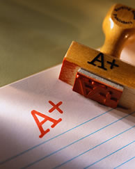 Image of a grading stamp marking a peice of lined paper with an A+
