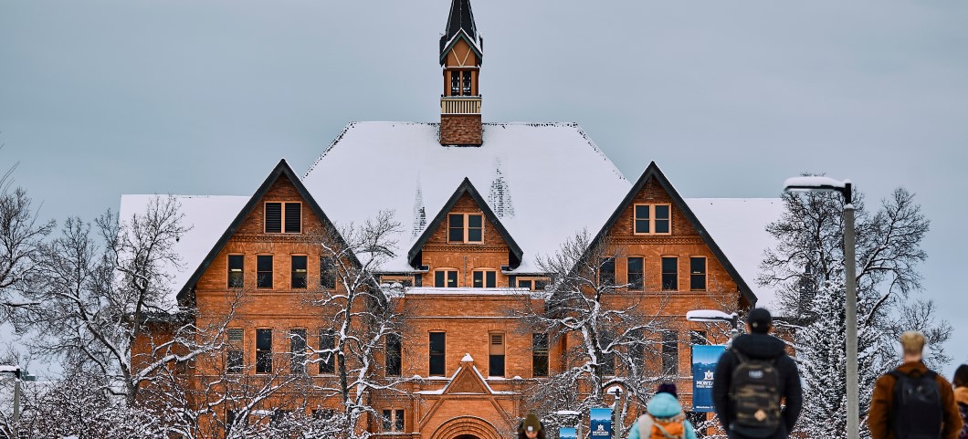 Montana Hall with students in snow