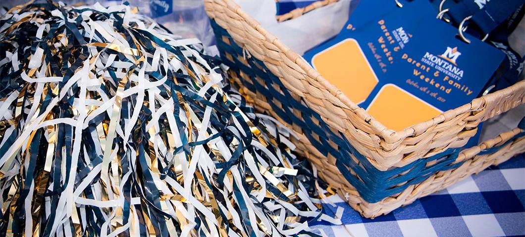 Photo of a blue and gold pom-pom and parent & family weekend name tags